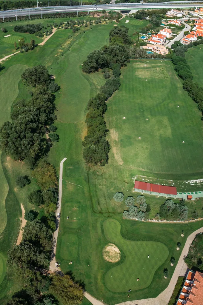 Hole 1 of Pestana Beloura Golf from the air, with Beloura’s homes around it