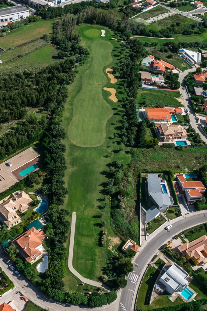 Hole 11 of Pestana Beloura Golf from the air, with Beloura’s homes around it