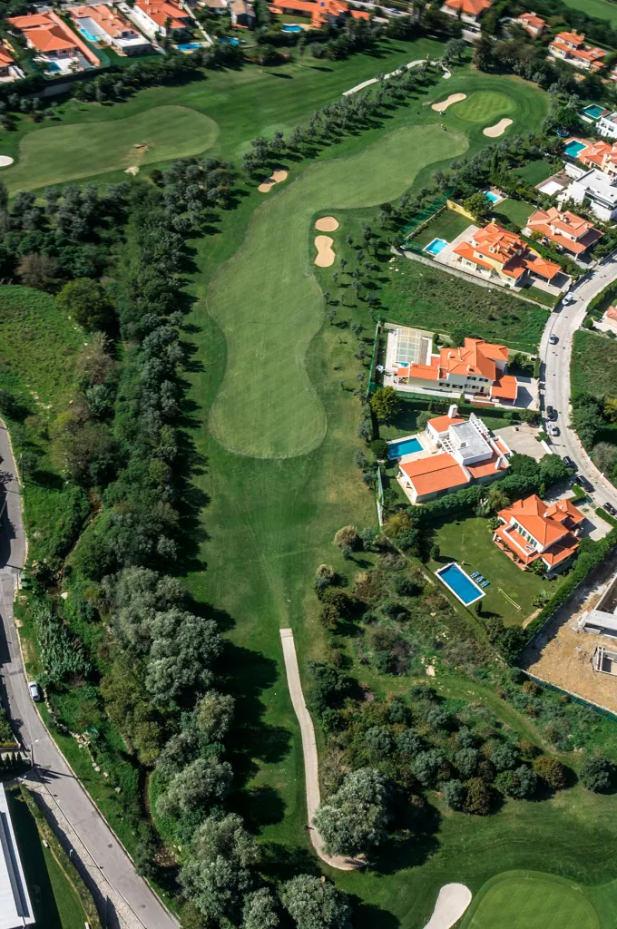 Hole 13 of Pestana Beloura Golf from the air, with Beloura’s homes around it