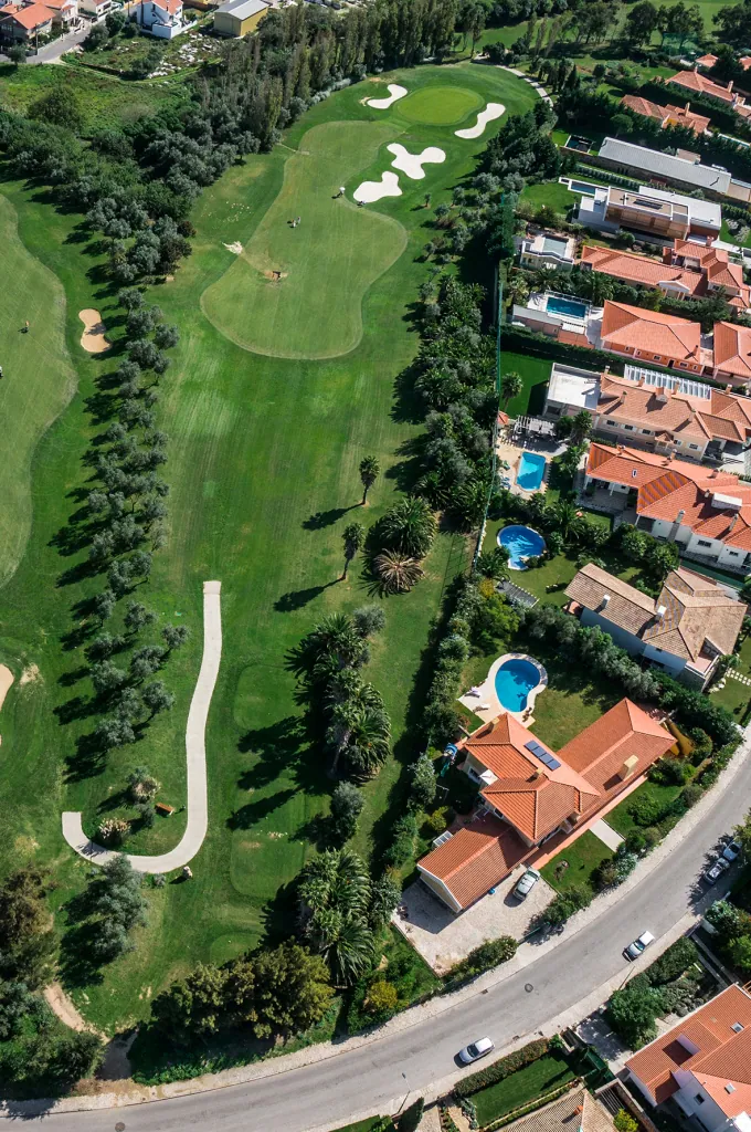 Hole 14 of Pestana Beloura Golf from the air, with Beloura’s homes around it