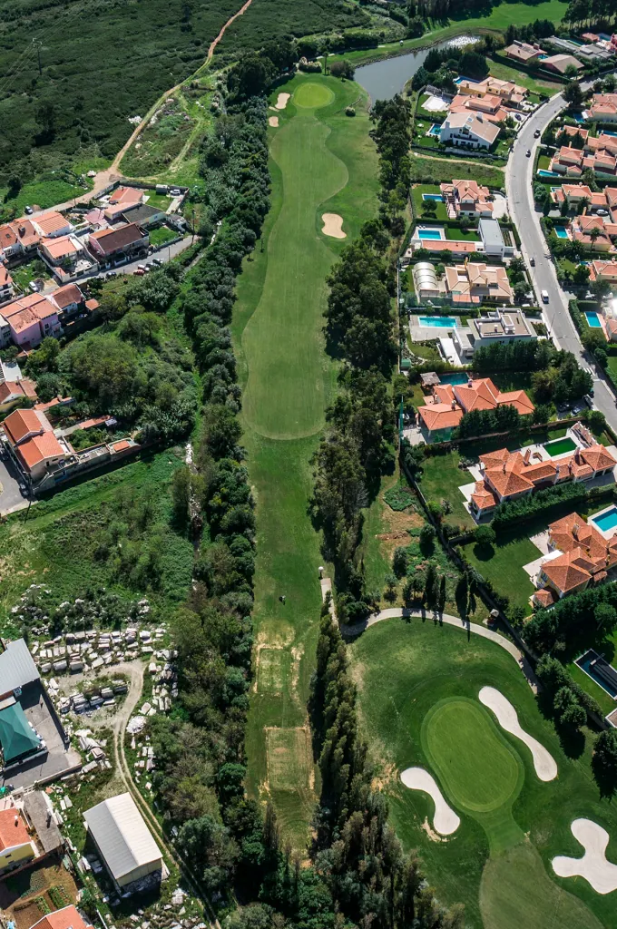 Hole 15 of Pestana Beloura Golf from the air, with Beloura’s homes around it