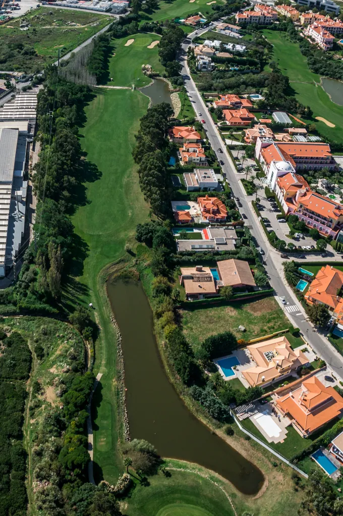Hole 16 of Pestana Beloura Golf from the air, with Beloura’s homes around it