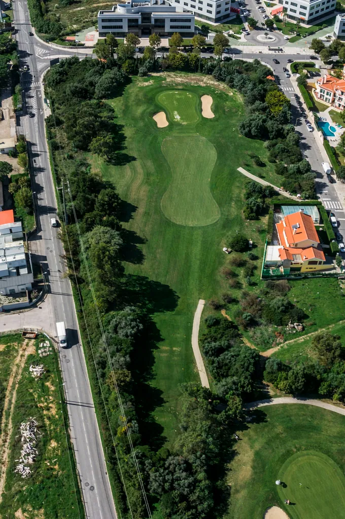 Hole 17 of Pestana Beloura Golf from the air, with Beloura’s homes around it