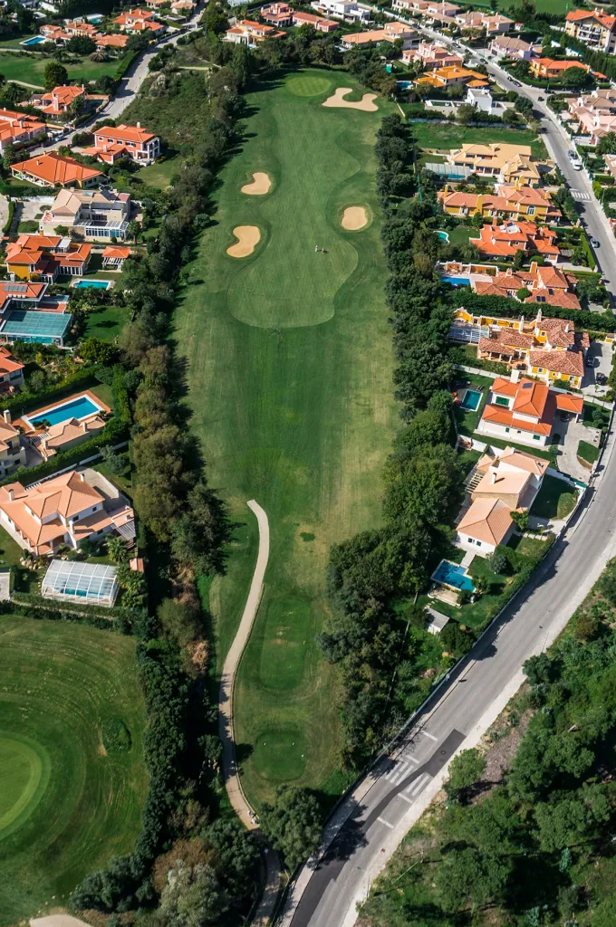 Hole 2 of Pestana Beloura Golf from the air, with Beloura’s homes around it