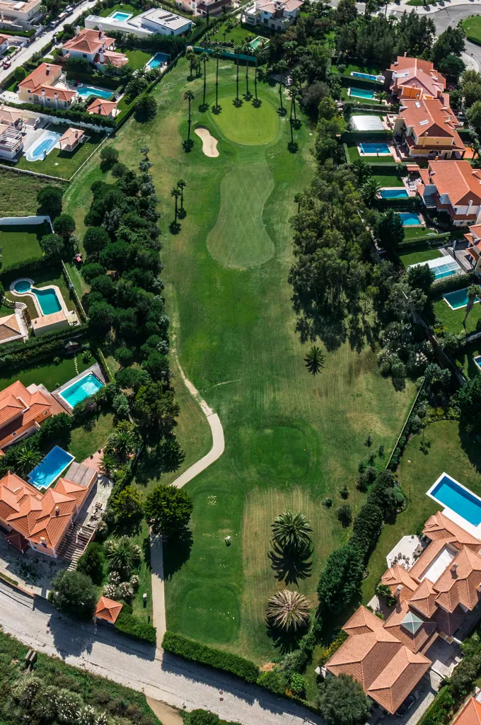 Hole 3 of Pestana Beloura Golf from the air, with Beloura’s homes around it