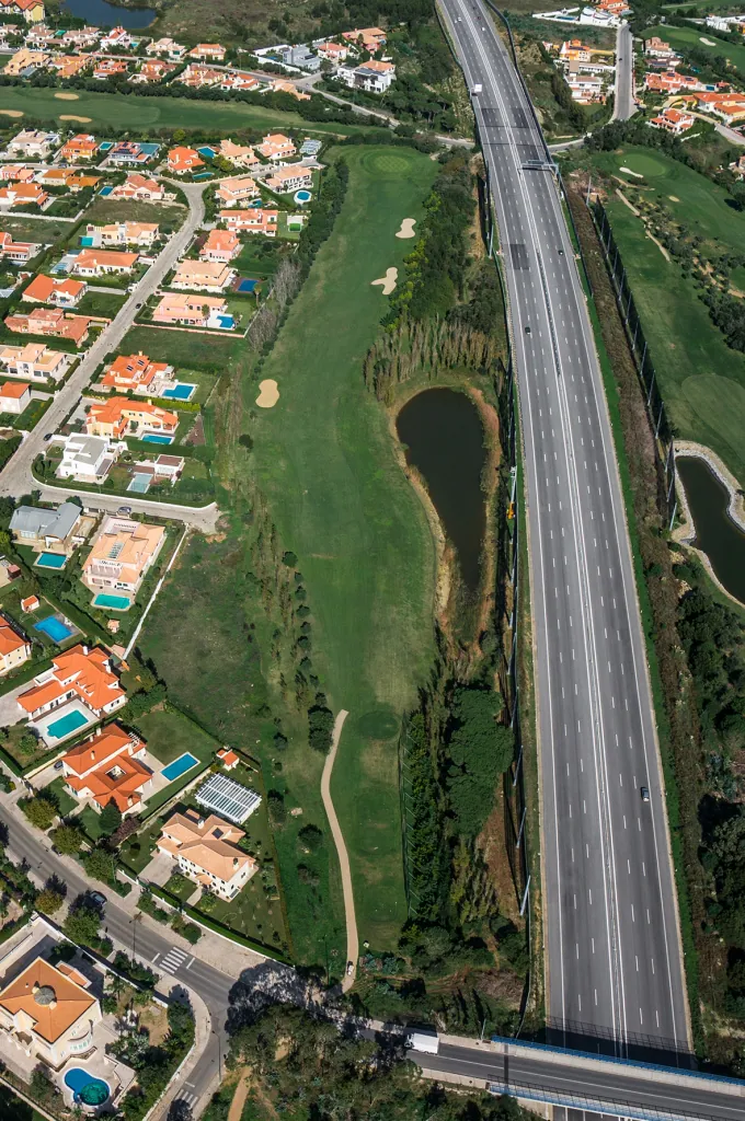 Hole 6 of Pestana Beloura Golf from the air, with Beloura’s homes around it