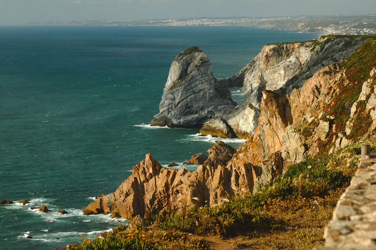 Praia da Ursa’s sea stacks and a turquoise Atlantic in golden light