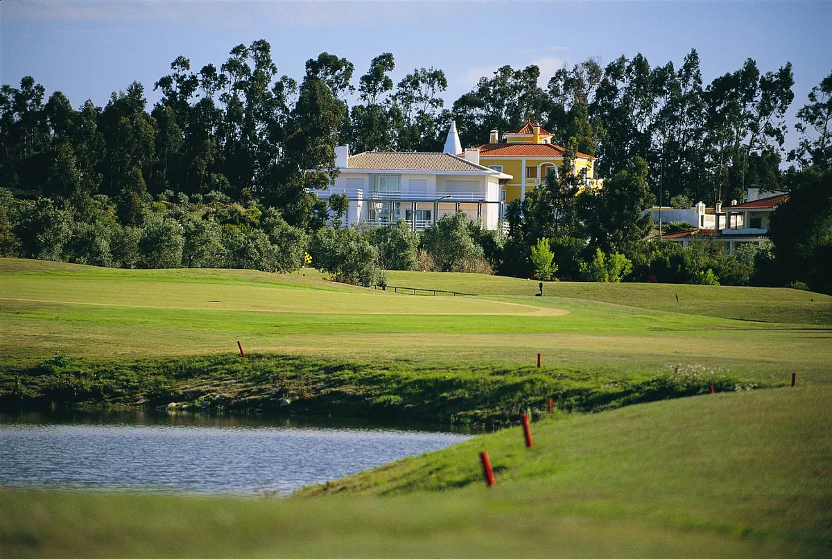 A white villa in Quinta da Beloura overlooking a lake on the golf course